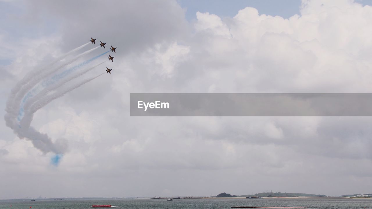 LOW ANGLE VIEW OF AIRPLANE FLYING IN SKY