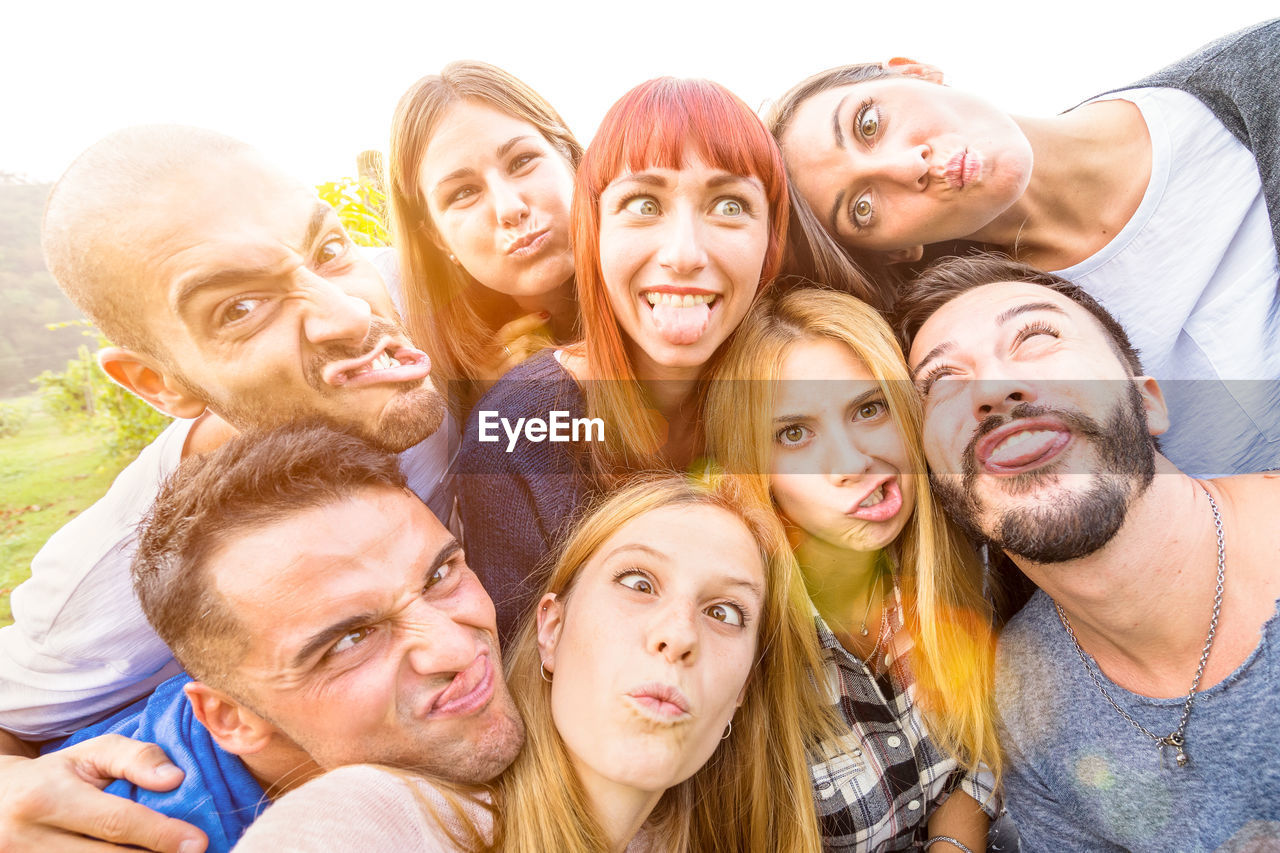 Portrait of friends making faces during party