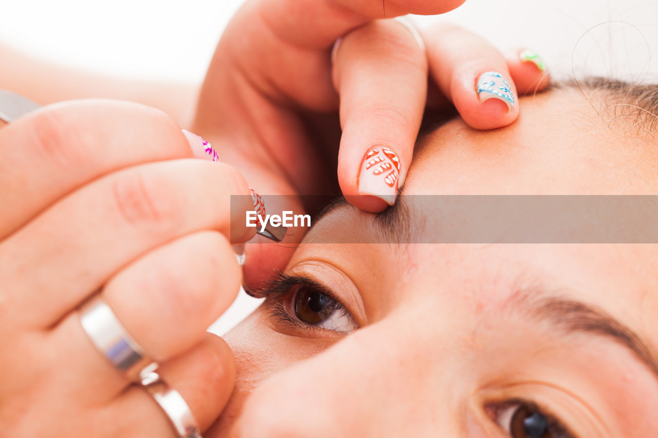 CLOSE-UP OF WOMAN HAND WITH TATTOO ON HANDS