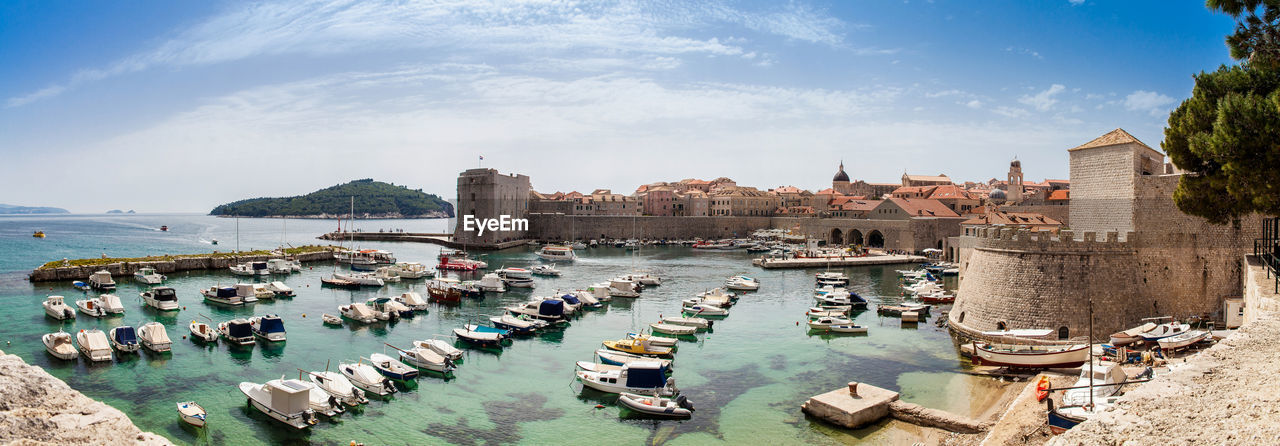 Mediterranean panorama of the beautiful dubrovnik old city, old port, city walls and fortifications.