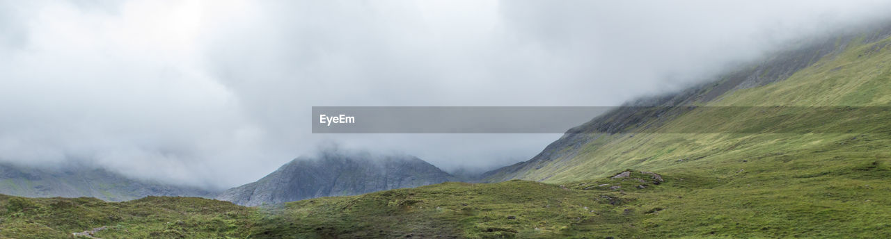 PANORAMIC VIEW OF MOUNTAINS AGAINST SKY