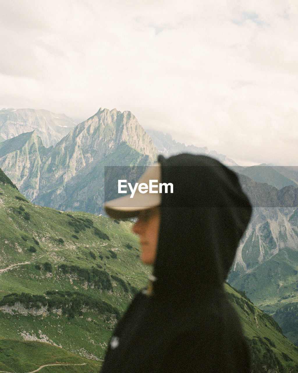 Rear view of girl standing on mountain near oberstdorf, germany. shot on 35mm kodak portra 800 film.