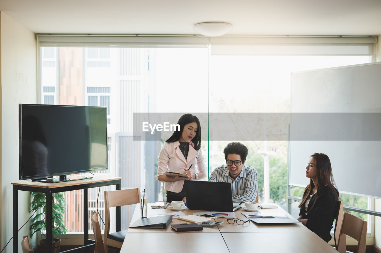 Business colleagues working at desk in creative office