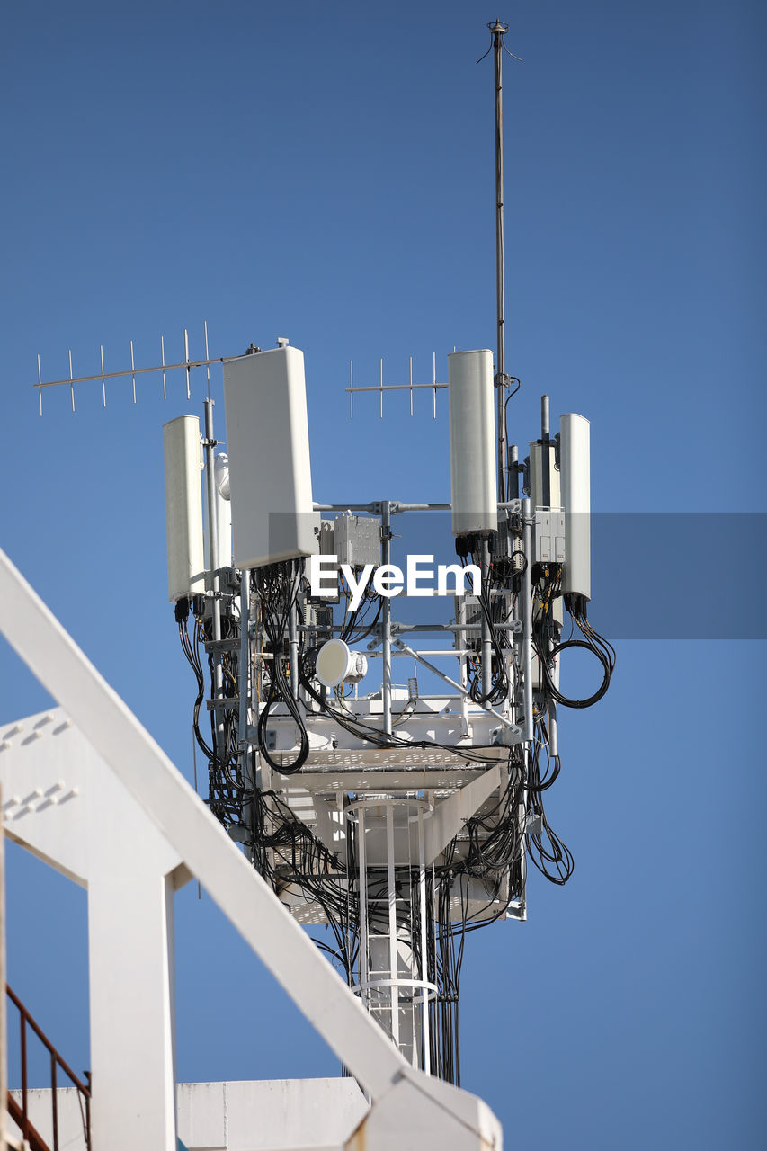 LOW ANGLE VIEW OF COMMUNICATIONS TOWER AGAINST SKY