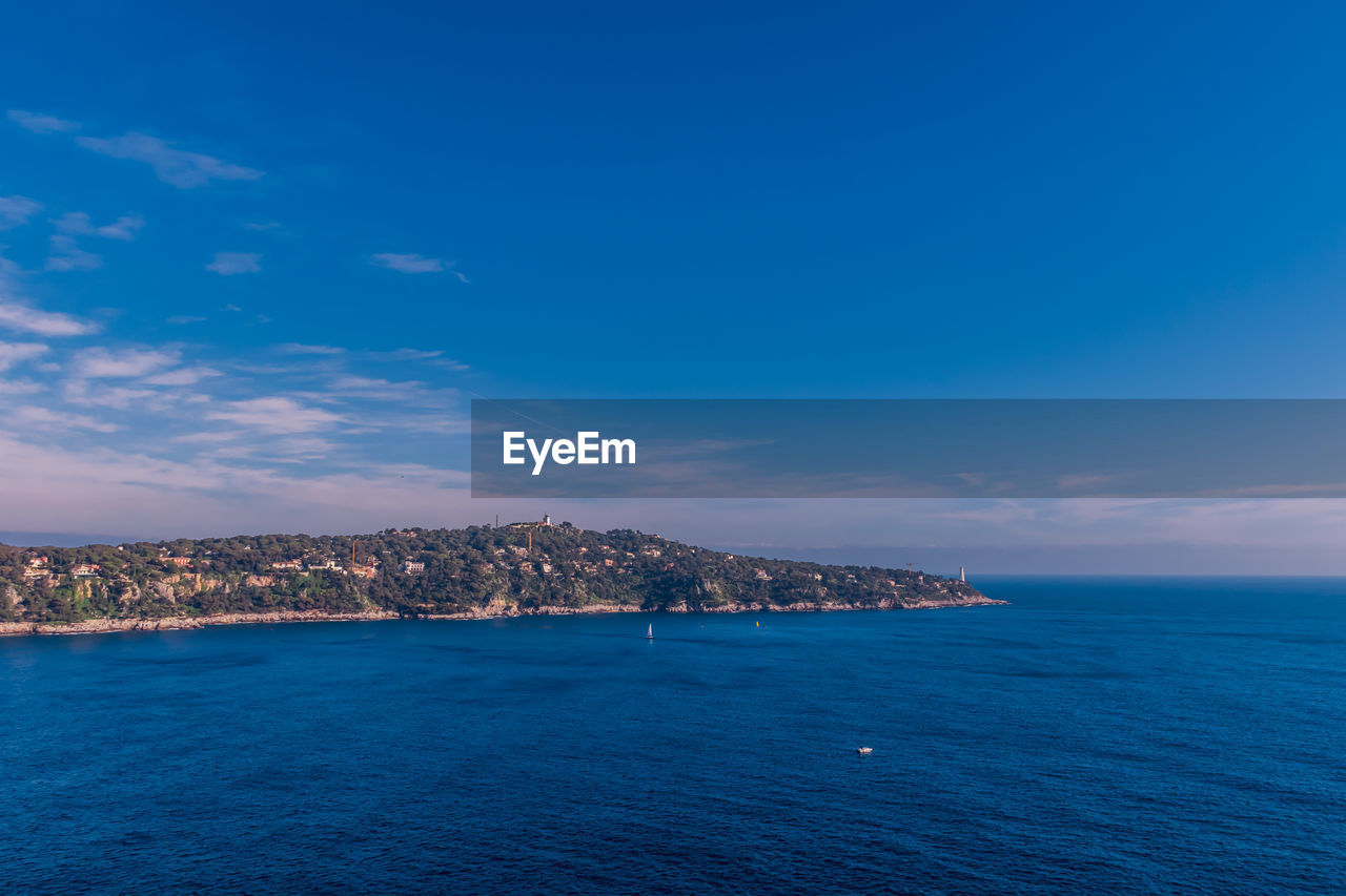 Scenic view of sea against blue sky