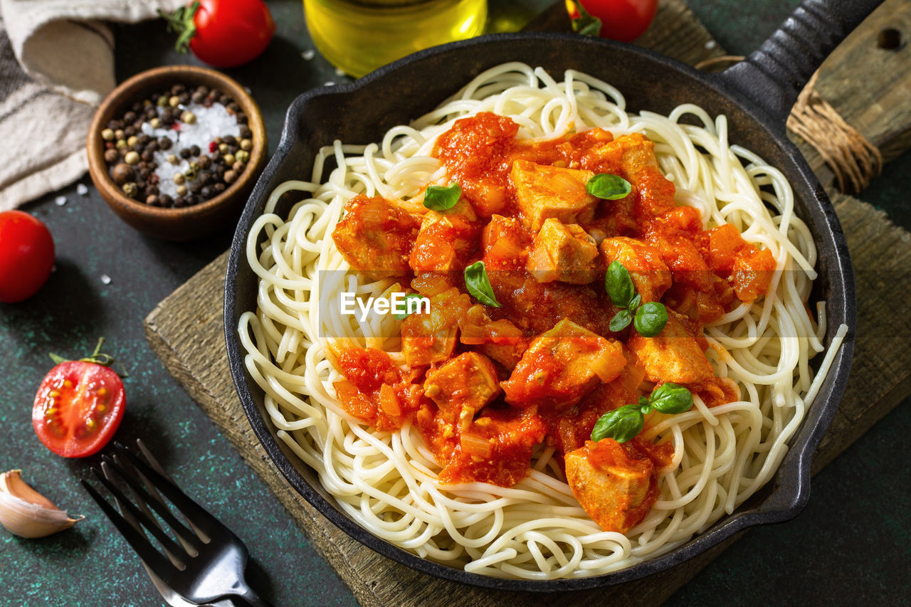 Healthy food, italian pasta. spaghetti with chicken and vegetables in tomato sauce. 