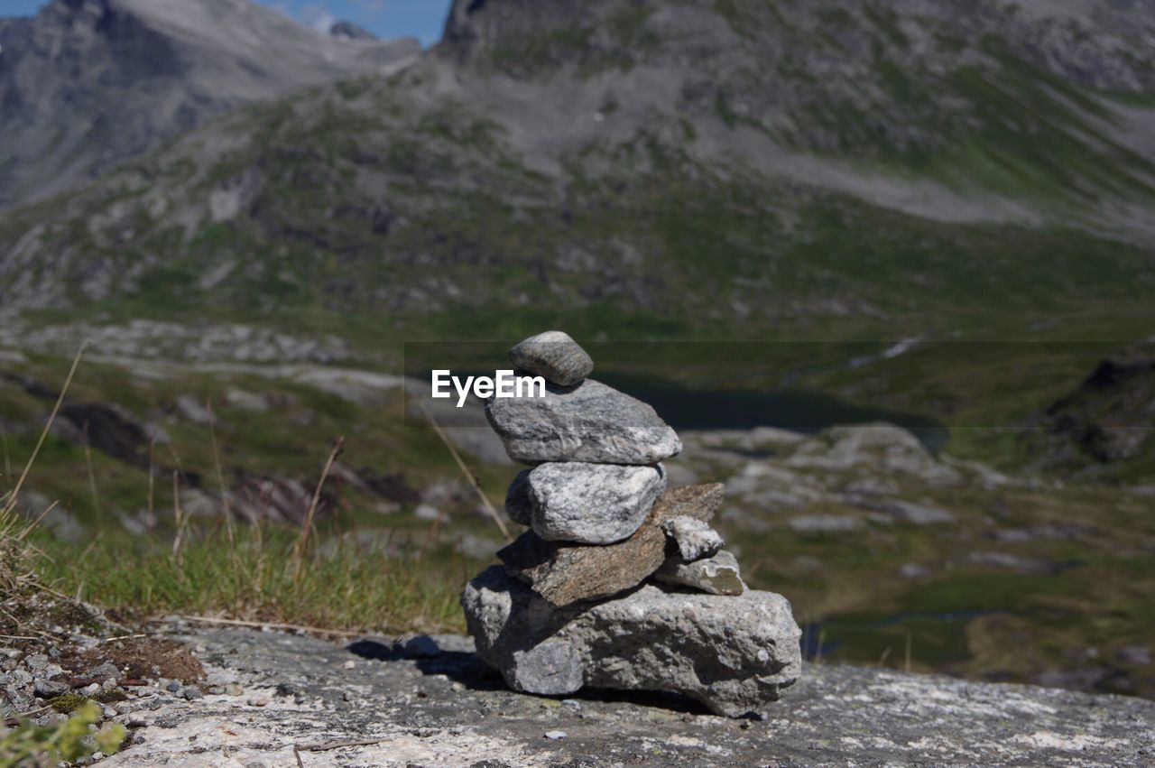 Close-up of statue on rock against sky