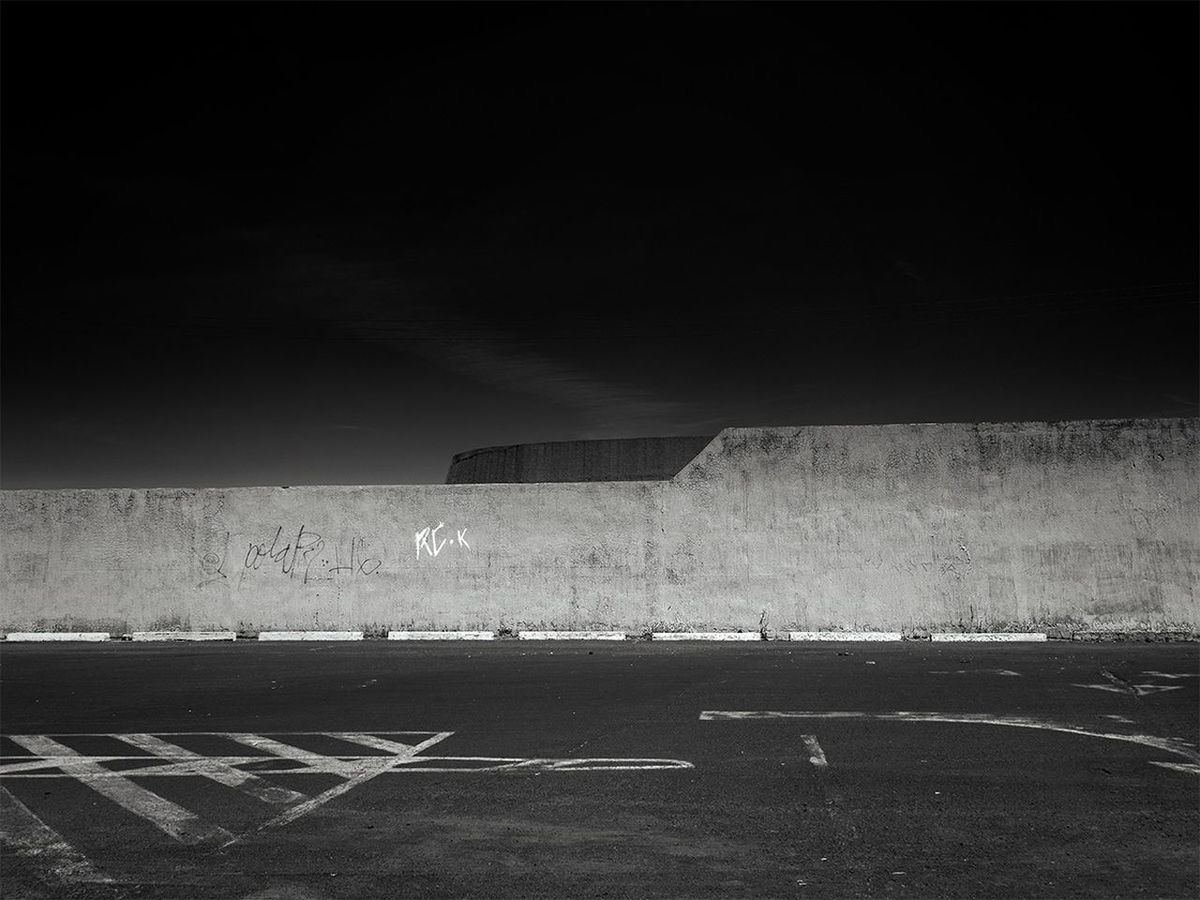 Street and surrounding wall against sky