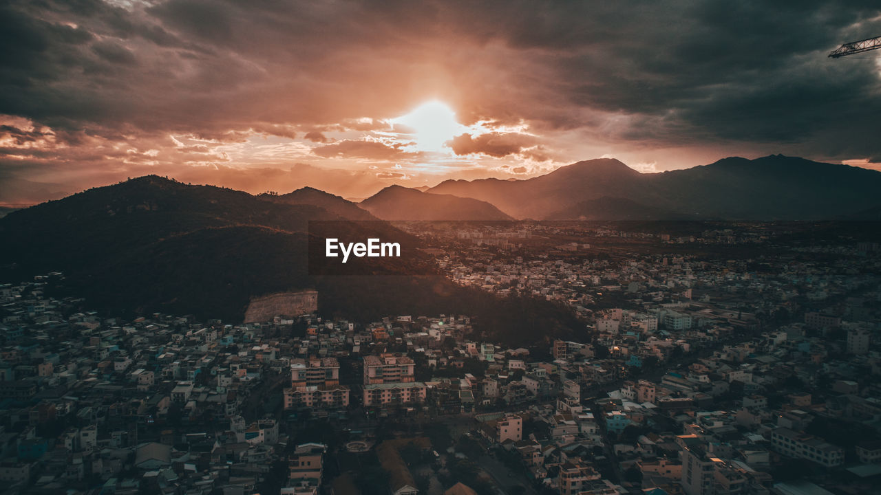 Aerial view of townscape against sky during sunset