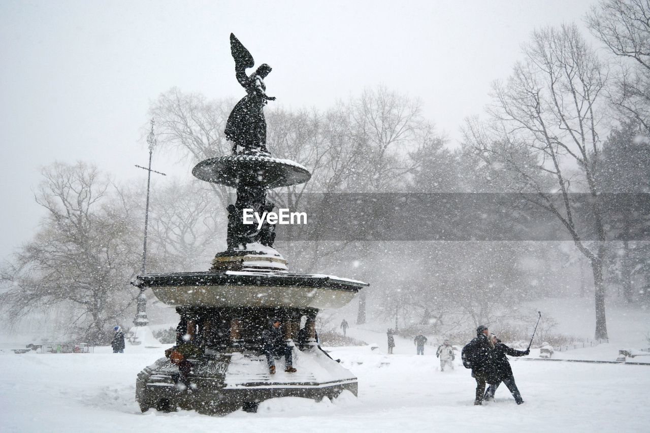 People traveling at central park during winter