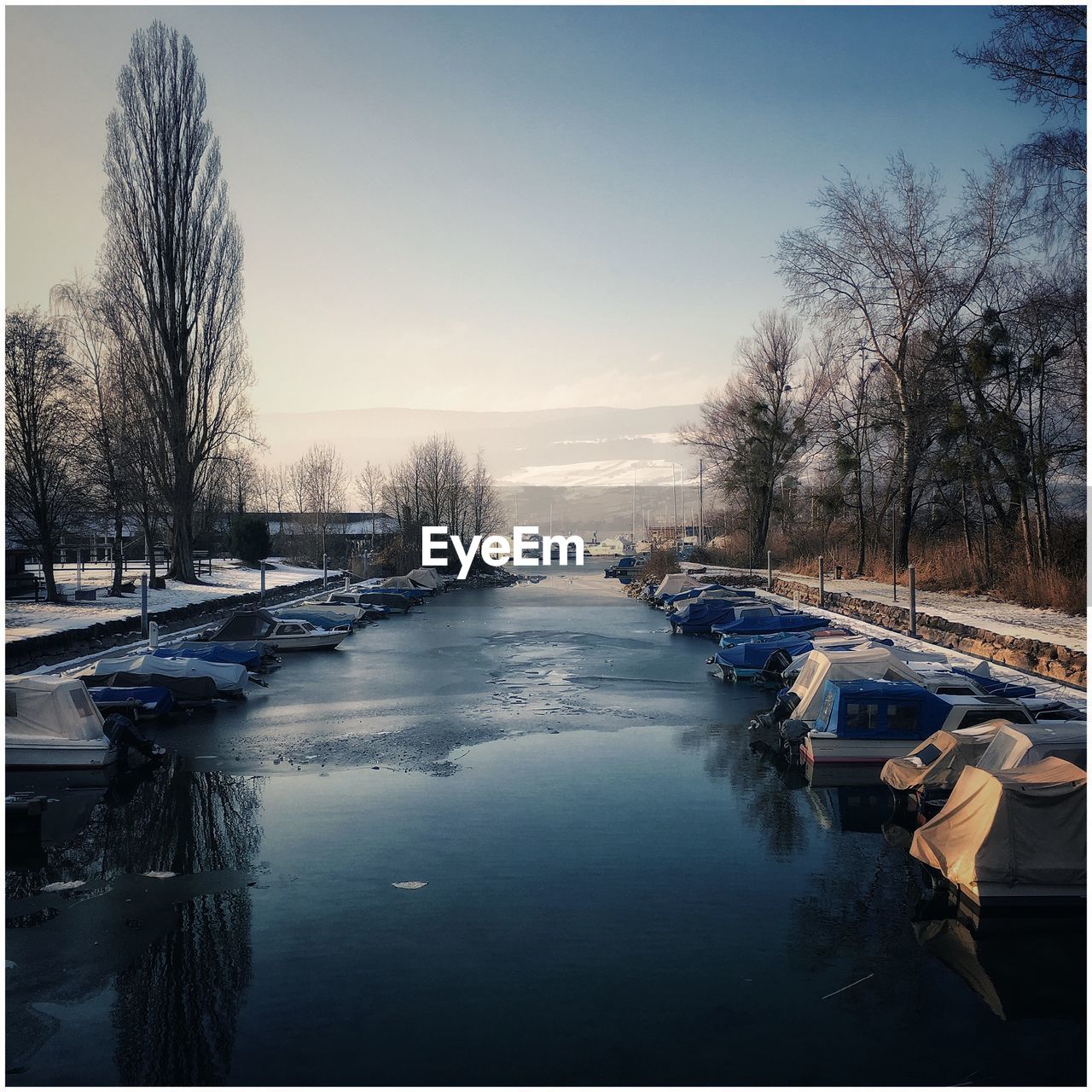 Scenic view of lake against clear sky during winter