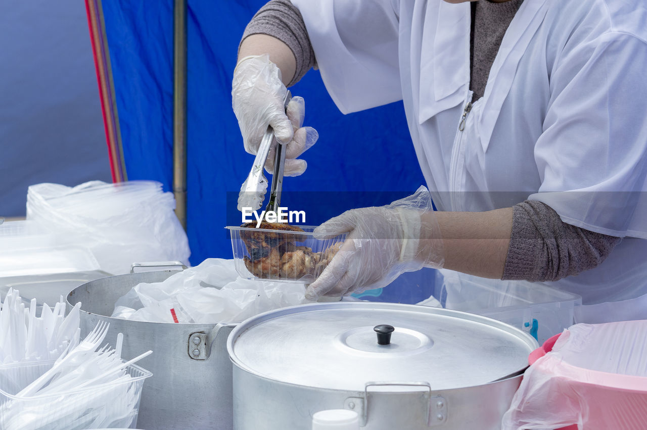 Midsection of woman packing food