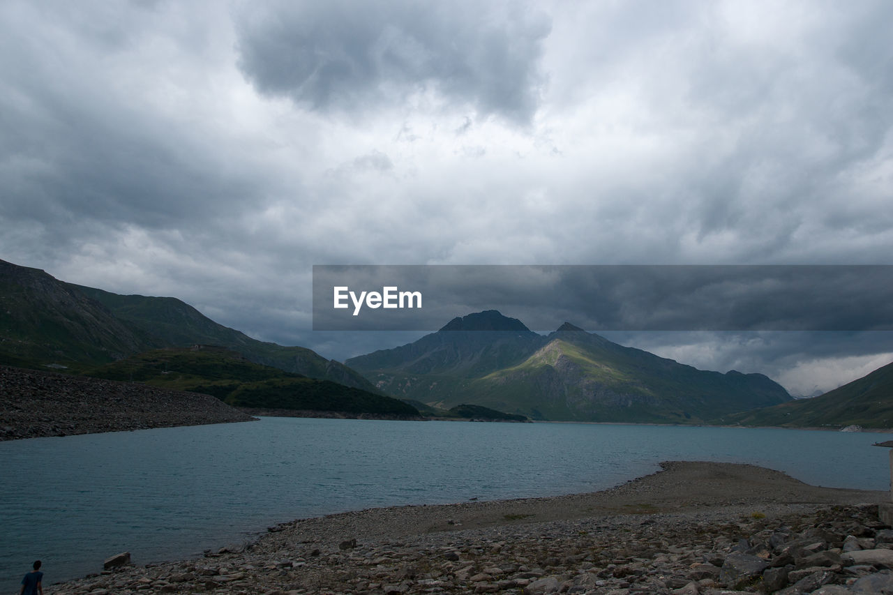 Scenic view of lake and mountains against sky