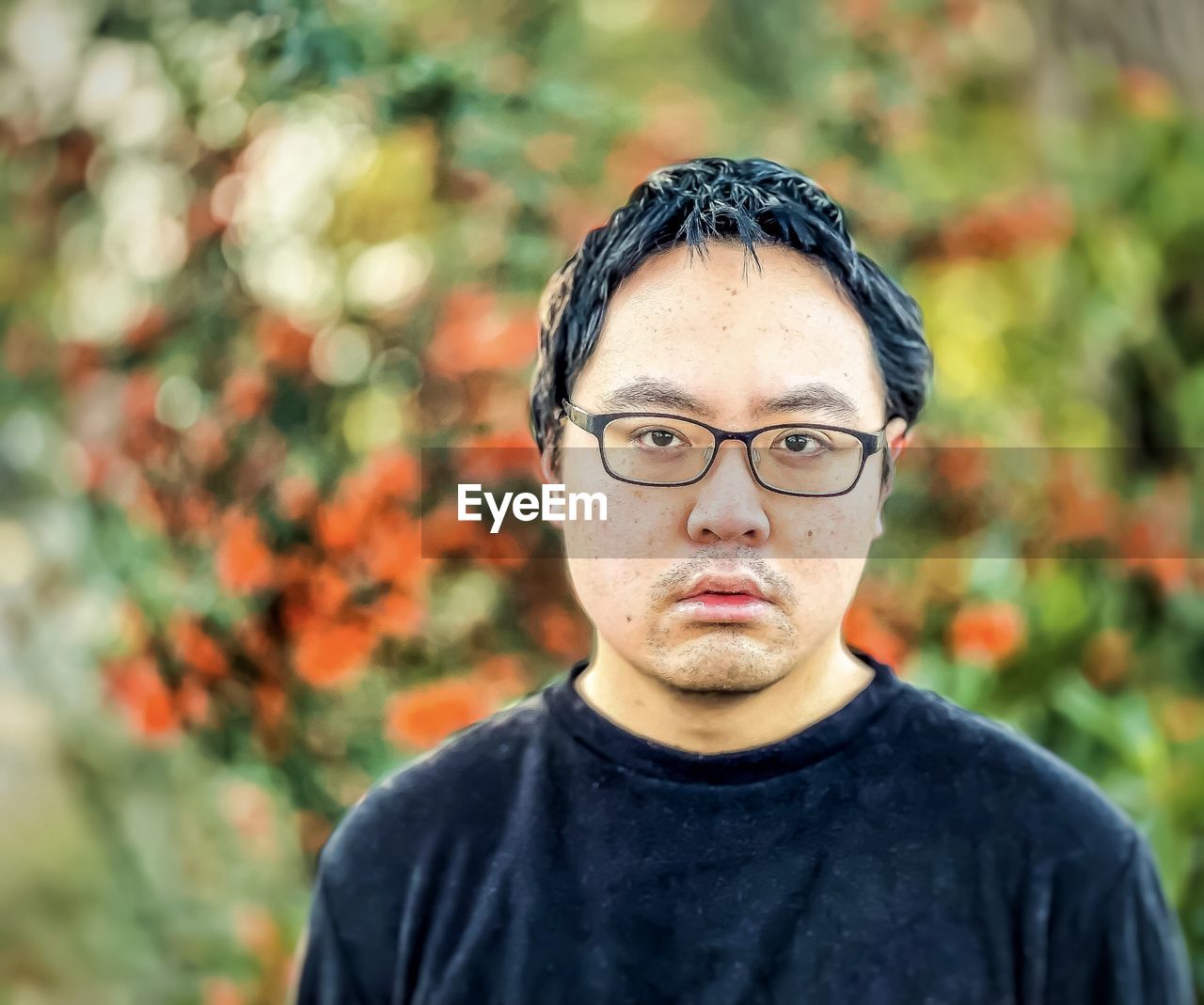 PORTRAIT OF YOUNG MAN WITH EYEGLASSES