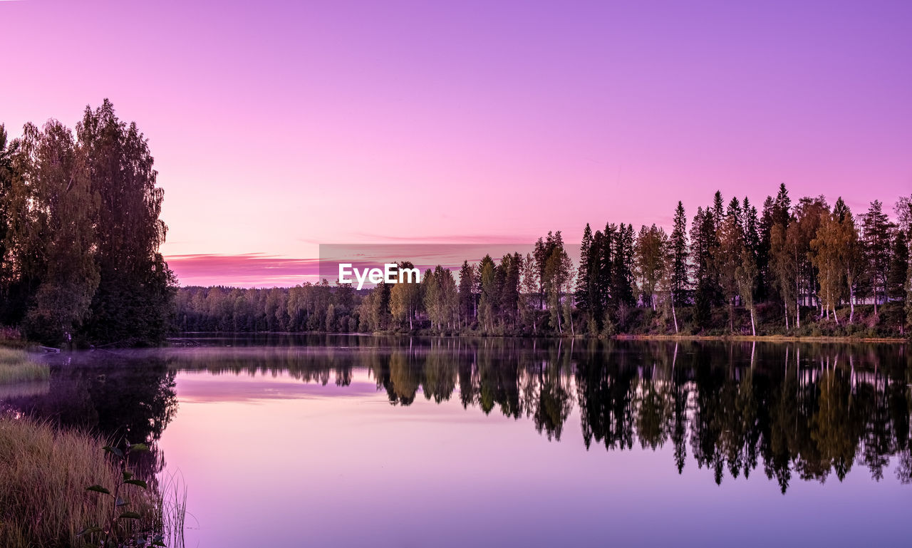 Scenic view of lake against sky during sunset