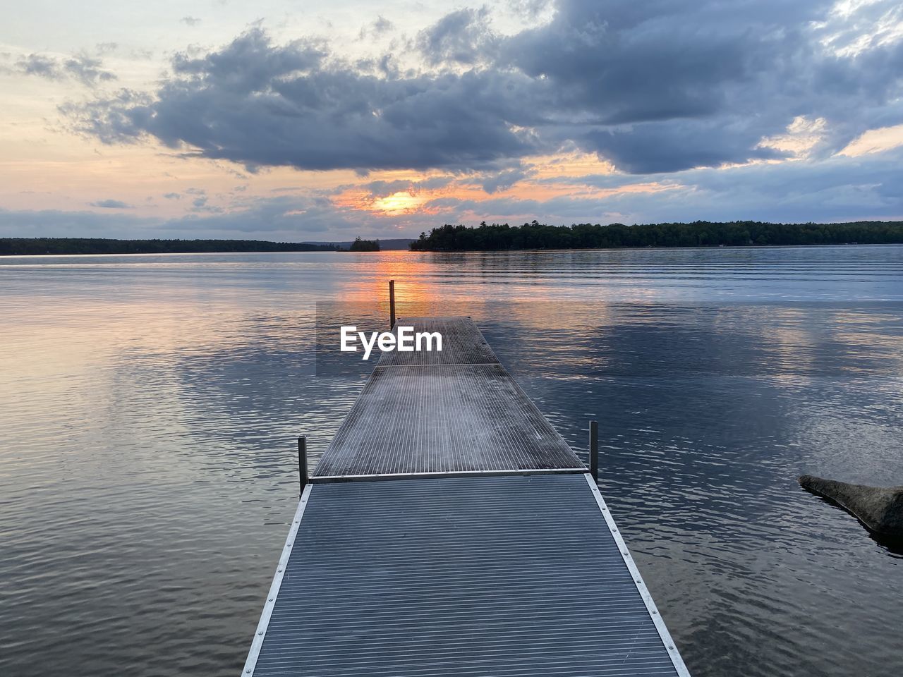 PIER ON LAKE AGAINST SKY