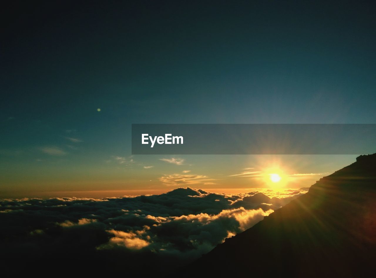 SCENIC VIEW OF MOUNTAINS AGAINST SKY DURING SUNSET