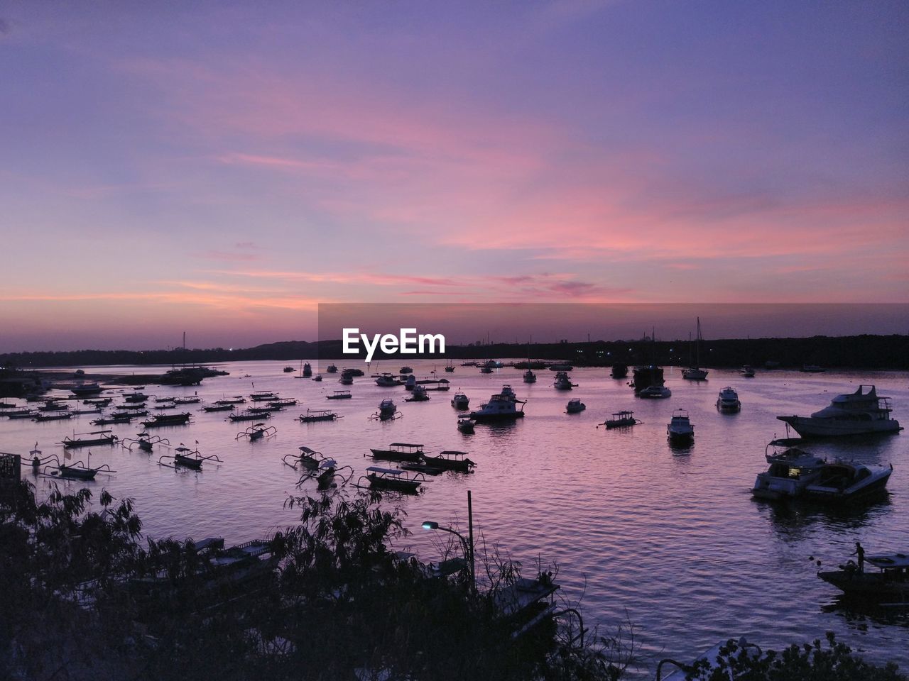 SCENIC VIEW OF LAKE AGAINST ORANGE SKY