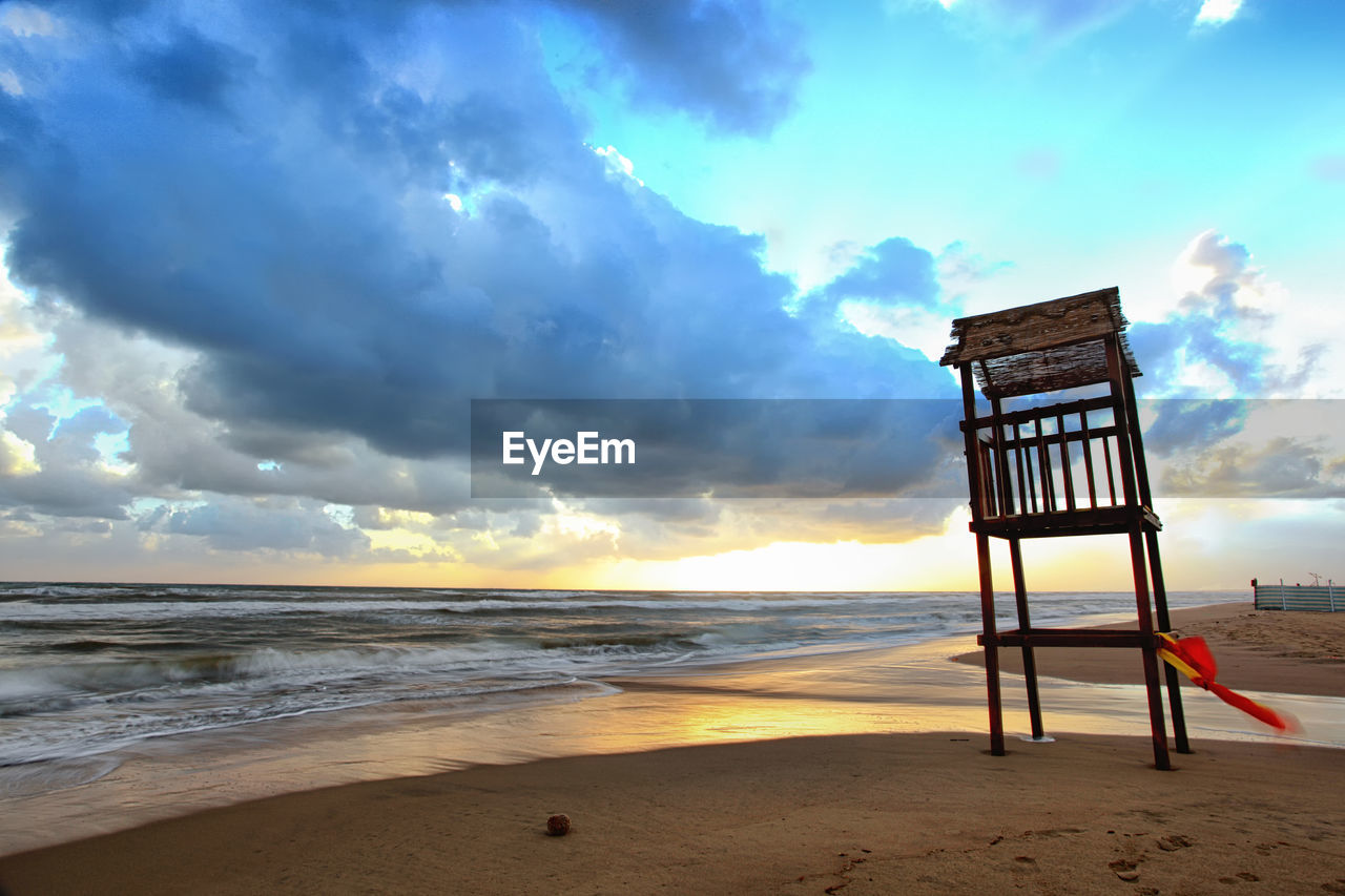 Lifeguard hut on the beach against sky.