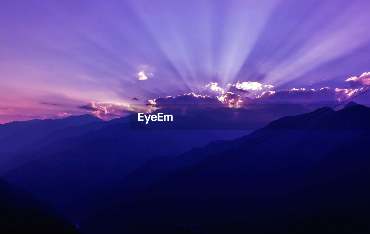SCENIC VIEW OF MOUNTAIN AGAINST SKY AT SUNSET