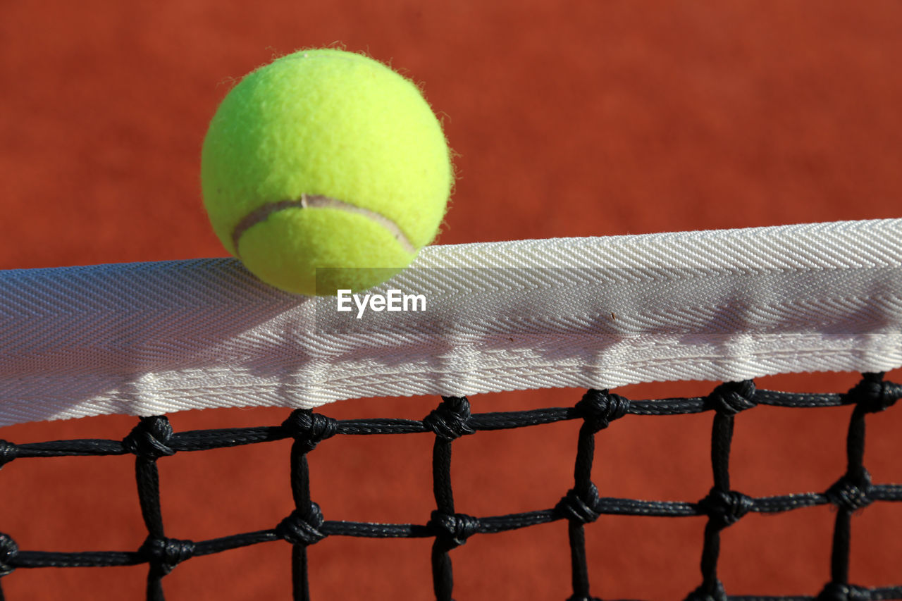 Close-up of yellow ball on the net 