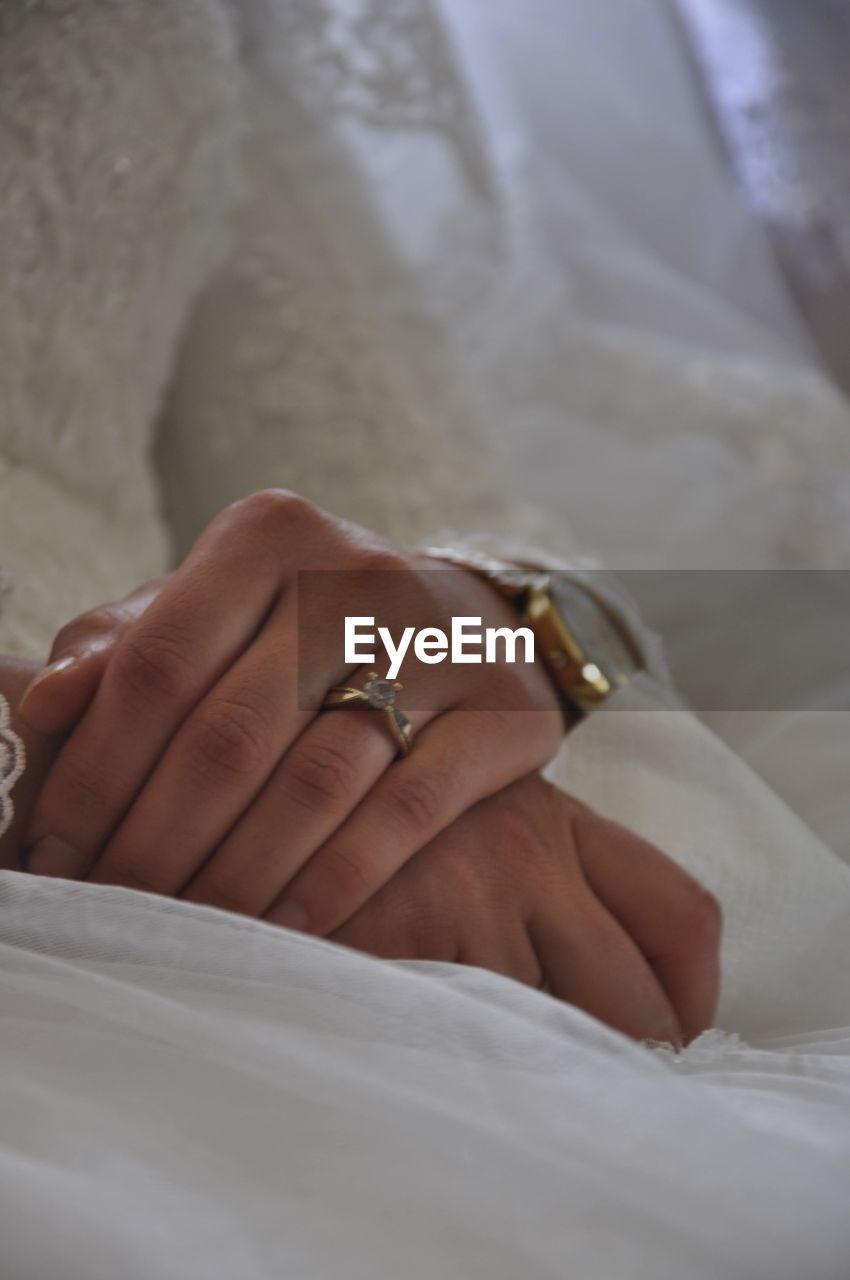 ring, jewelry, wedding, bride, newlywed, hand, life events, adult, women, event, celebration, love, married, wedding dress, wedding ring, positive emotion, ceremony, emotion, bed, wedding ceremony, romance, female, two people, togetherness, engagement ring, indoors, close-up, bedroom, furniture, fashion accessory, diamond, holding hands, finger, dedication, white, men, diamond ring, beginnings, bonding, lifestyles, jewellery, engagement, linen, clothing, young adult, tradition