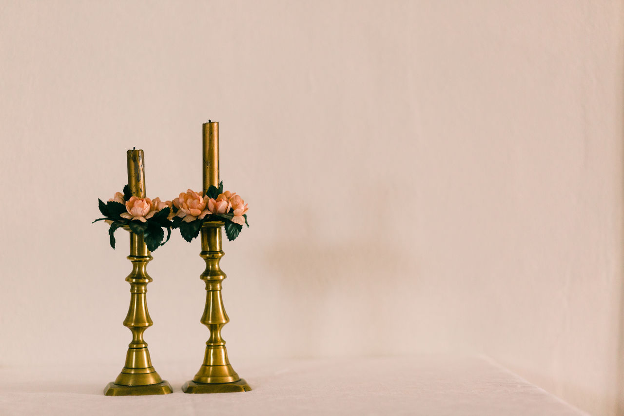 Close-up of candlestick holder against wall