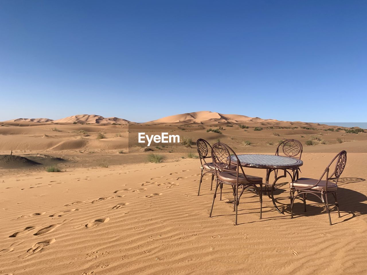 BICYCLE ON SAND AGAINST CLEAR SKY