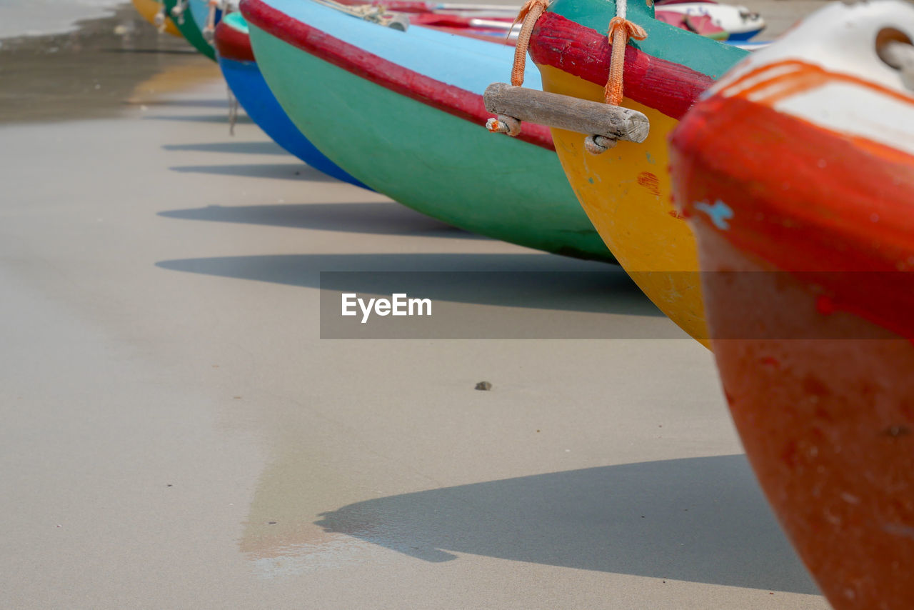 CLOSE-UP OF RED BOATS MOORED ON SHORE