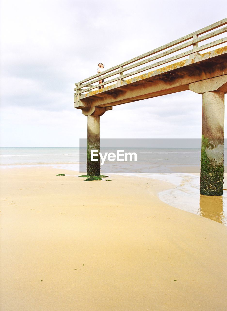 Heterosexual couple standing on pier