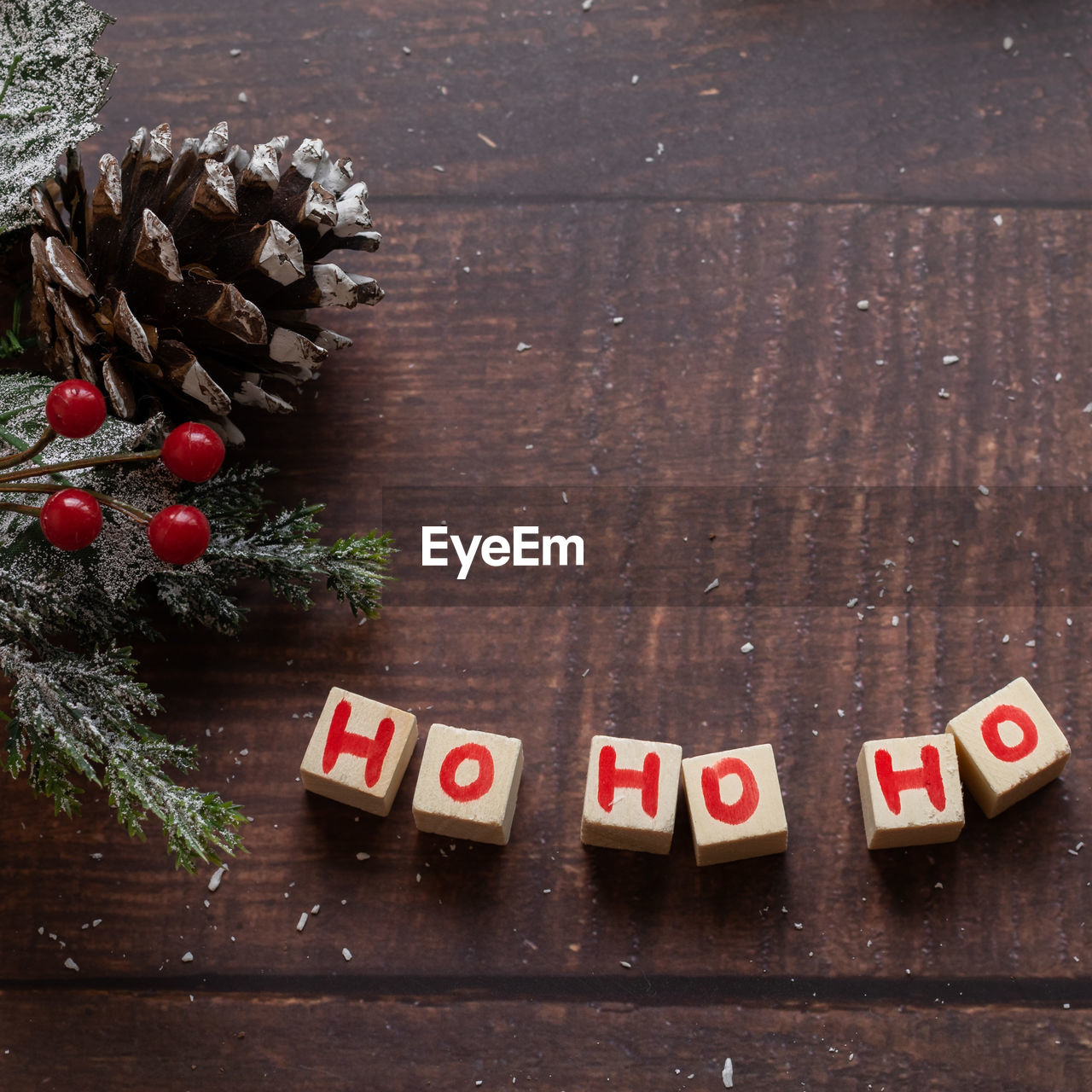 Christmas festive gift box and sweets with seasons decorations on wooden background