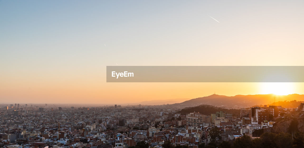 TOWNSCAPE AGAINST SKY DURING SUNSET