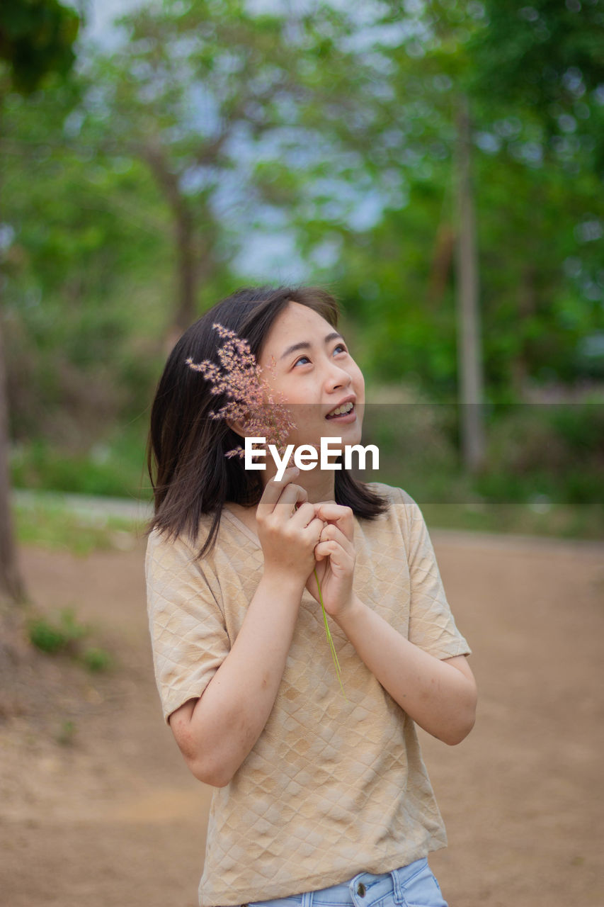 Portrait of smiling young woman standing outdoors