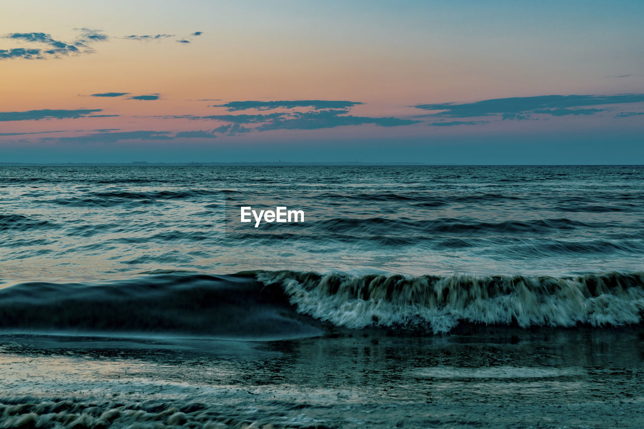 scenic view of sea against orange sky