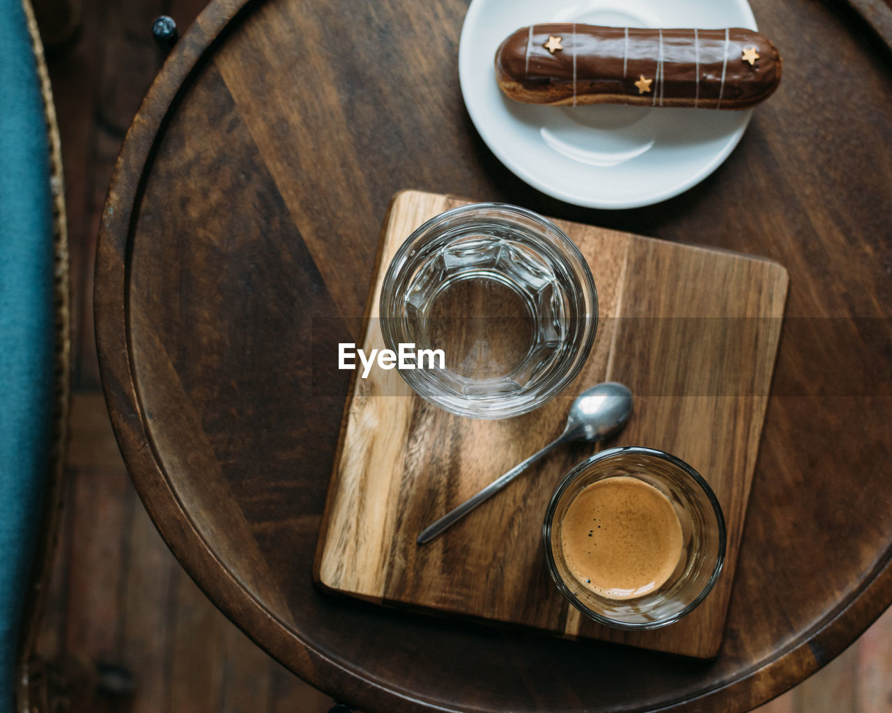 Directly above shot of coffee and pastry served on wooden table