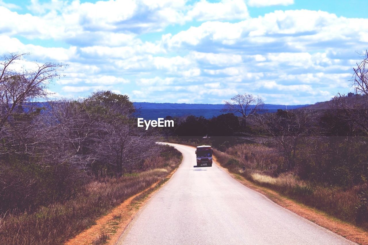 CARS ON ROAD AGAINST SKY