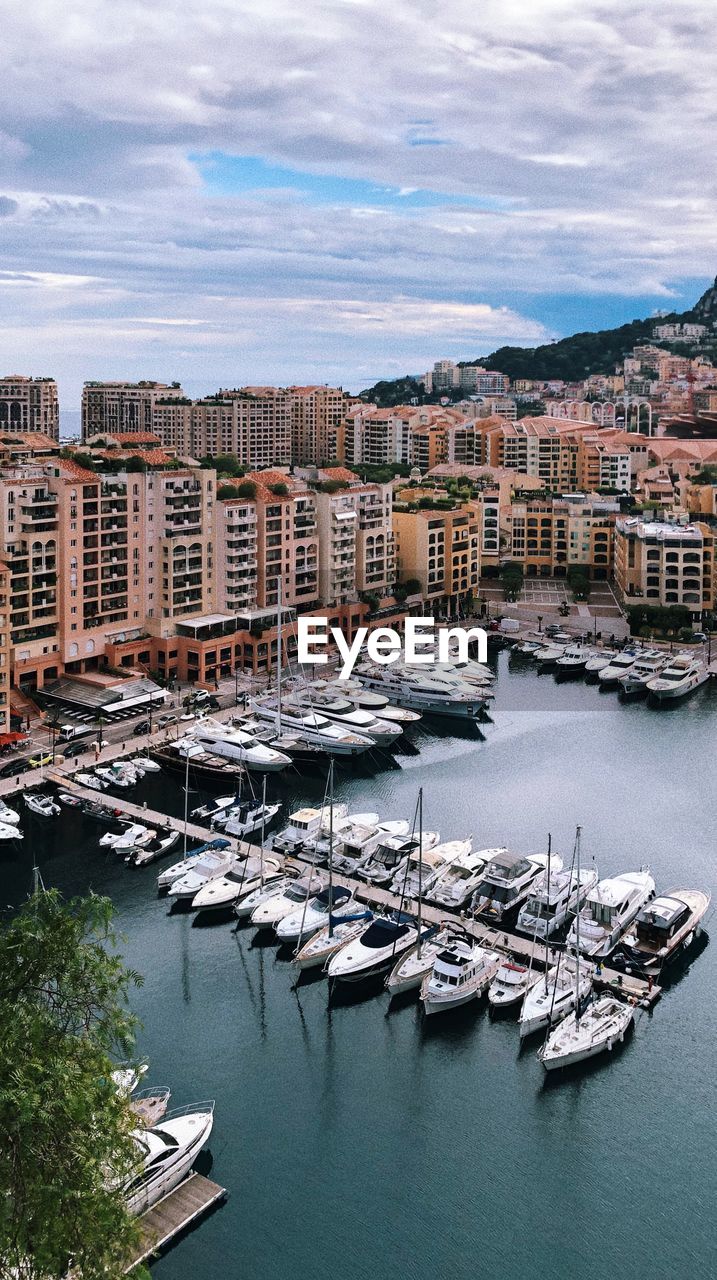 High angle view of marina and buildings against sky