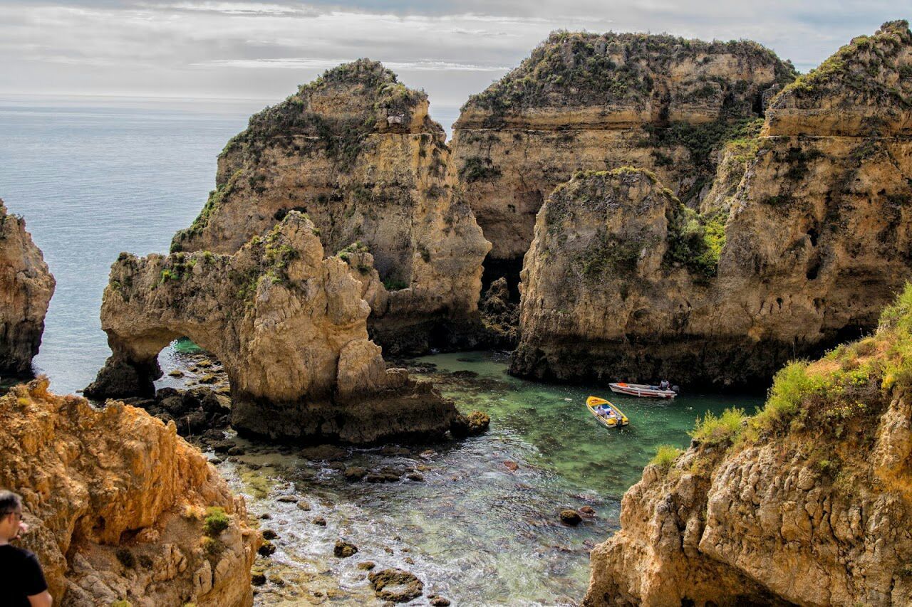 High angle view of boats moored by rock formation at praia do camilo