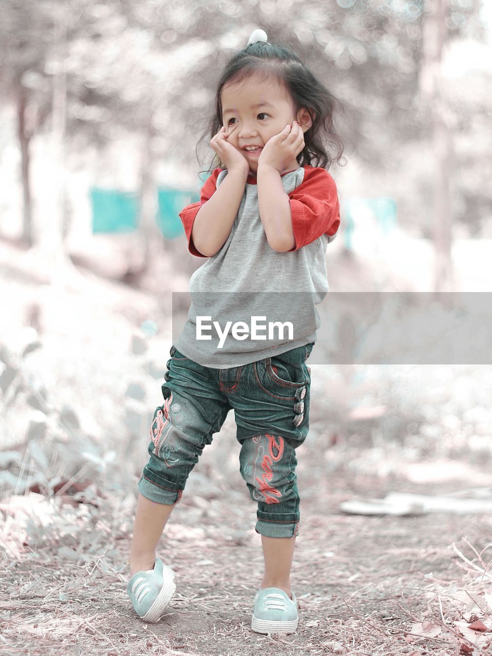 Smiling girl standing on field