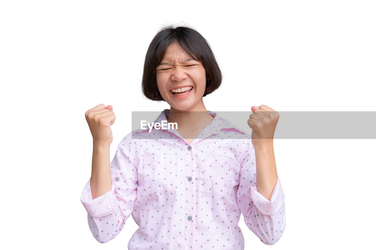 Cheerful girl standing against white background