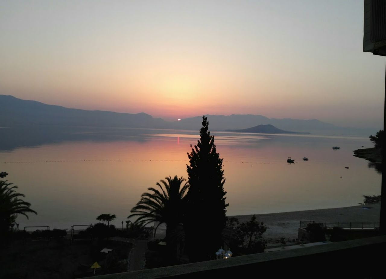 VIEW OF LAKE AGAINST SKY DURING SUNSET