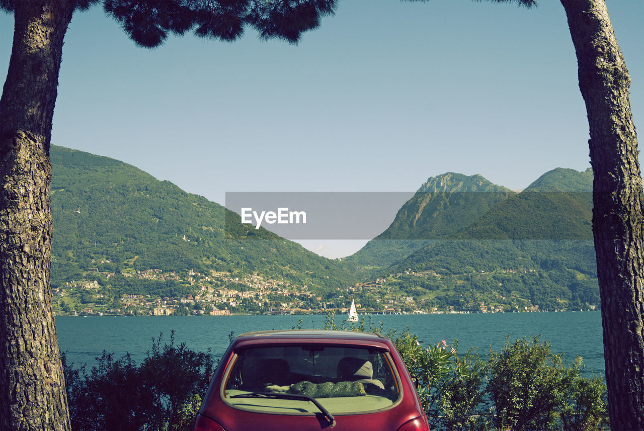 SCENIC VIEW OF MOUNTAINS AND SEA AGAINST SKY