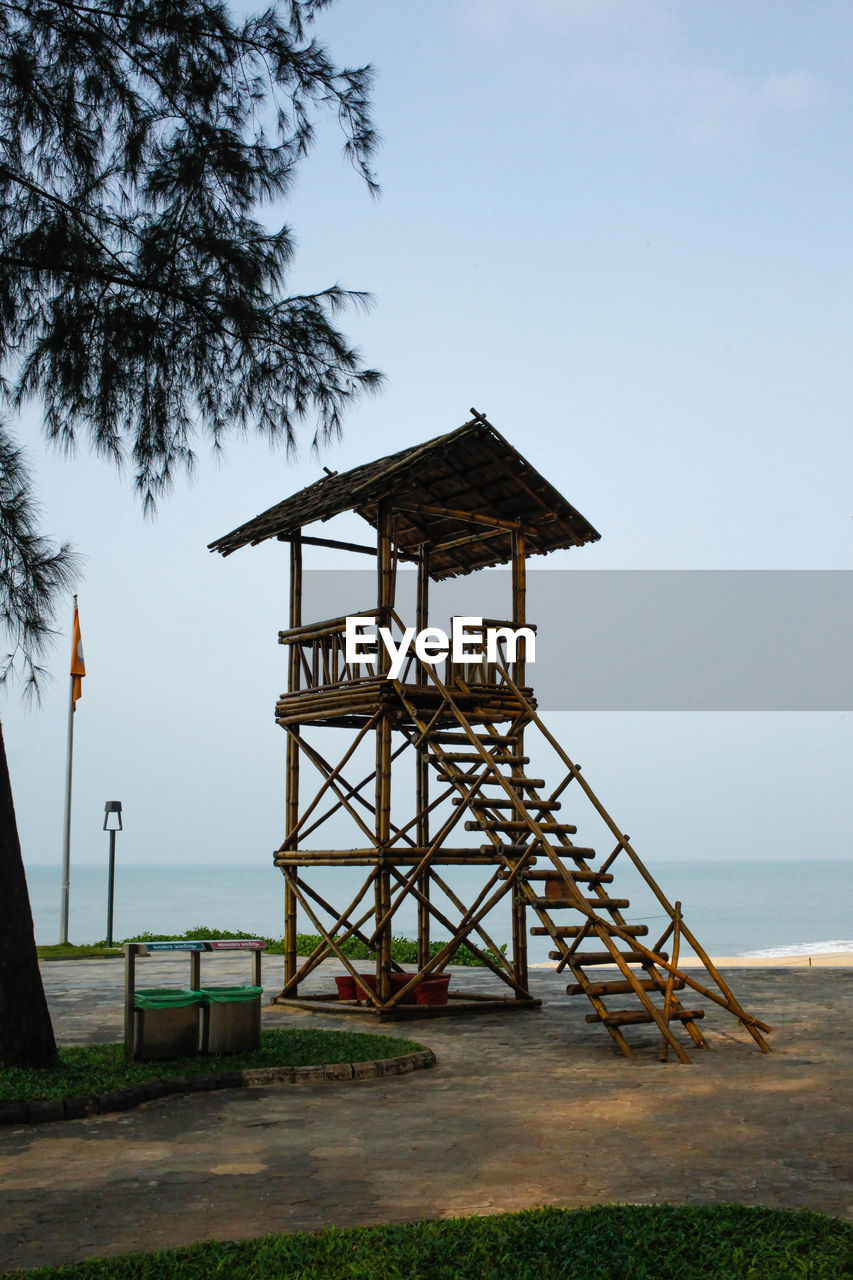 lifeguard hut on beach against sky