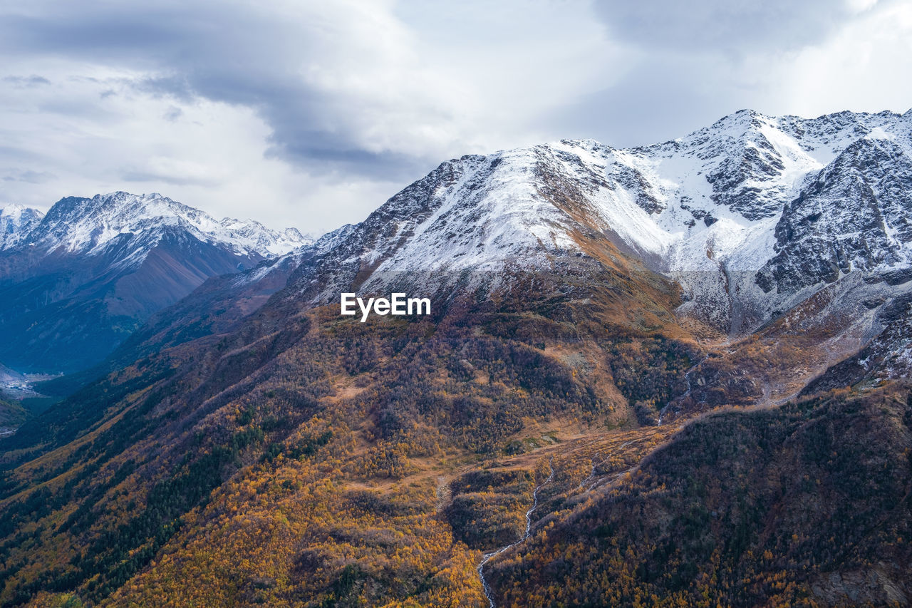 View from above on the slopes of the mountains, overgrown with forest in autumn. mountains, tourism.