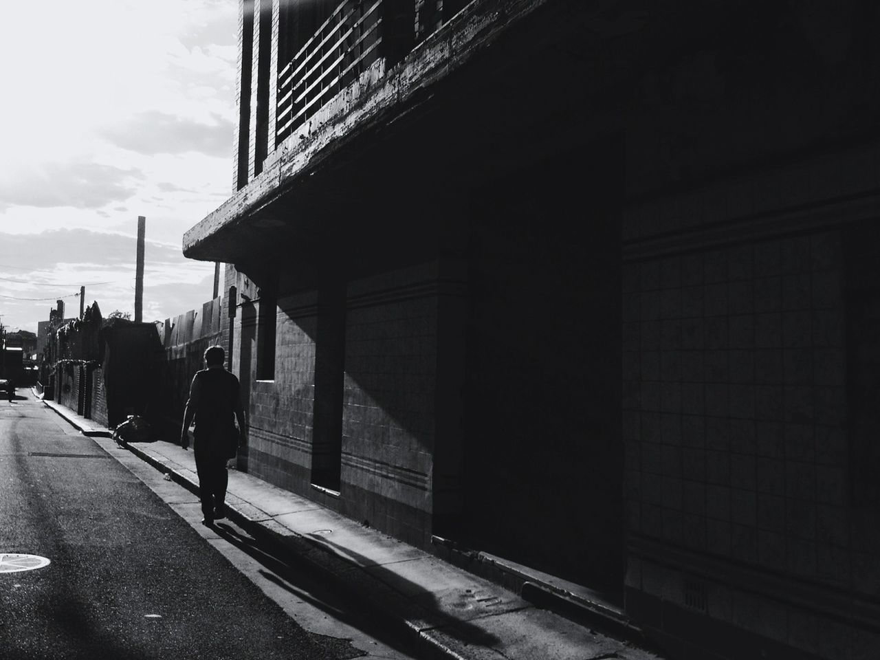 Pedestrian walking past building