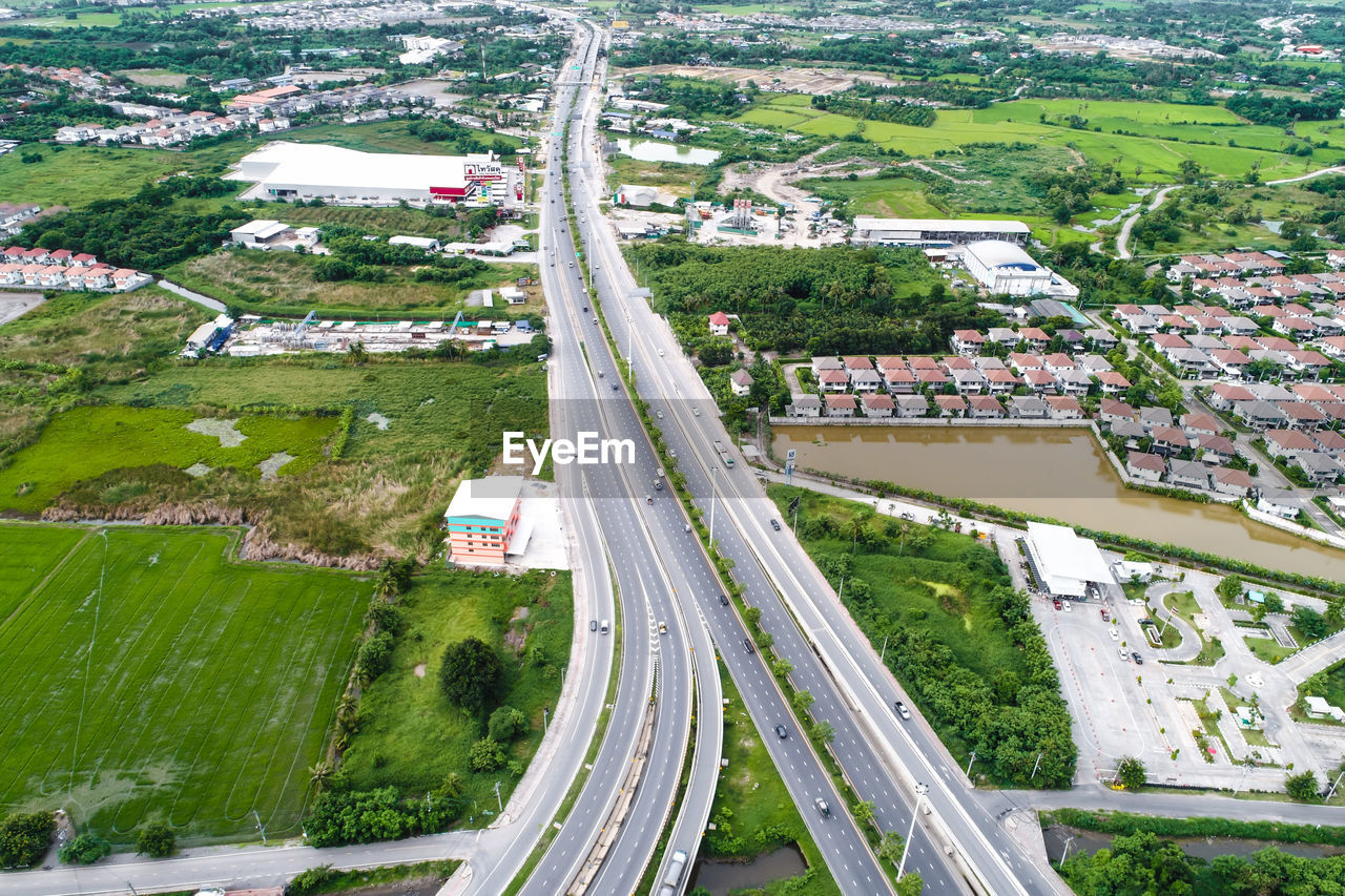 HIGH ANGLE VIEW OF STREET AMIDST TREES IN CITY