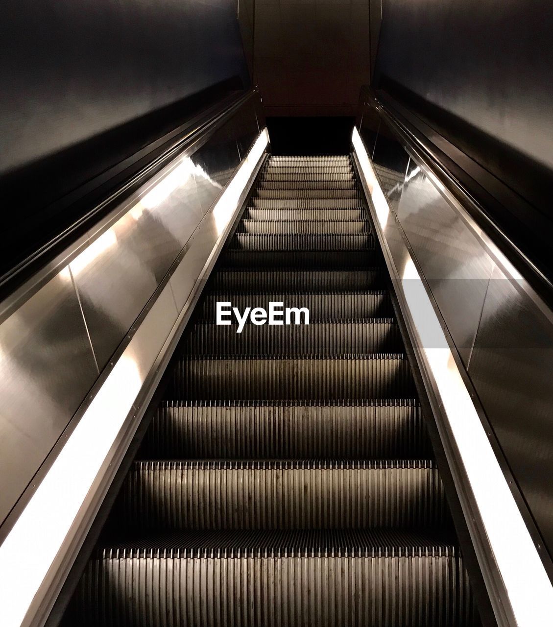 HIGH ANGLE VIEW OF ESCALATOR IN SUBWAY