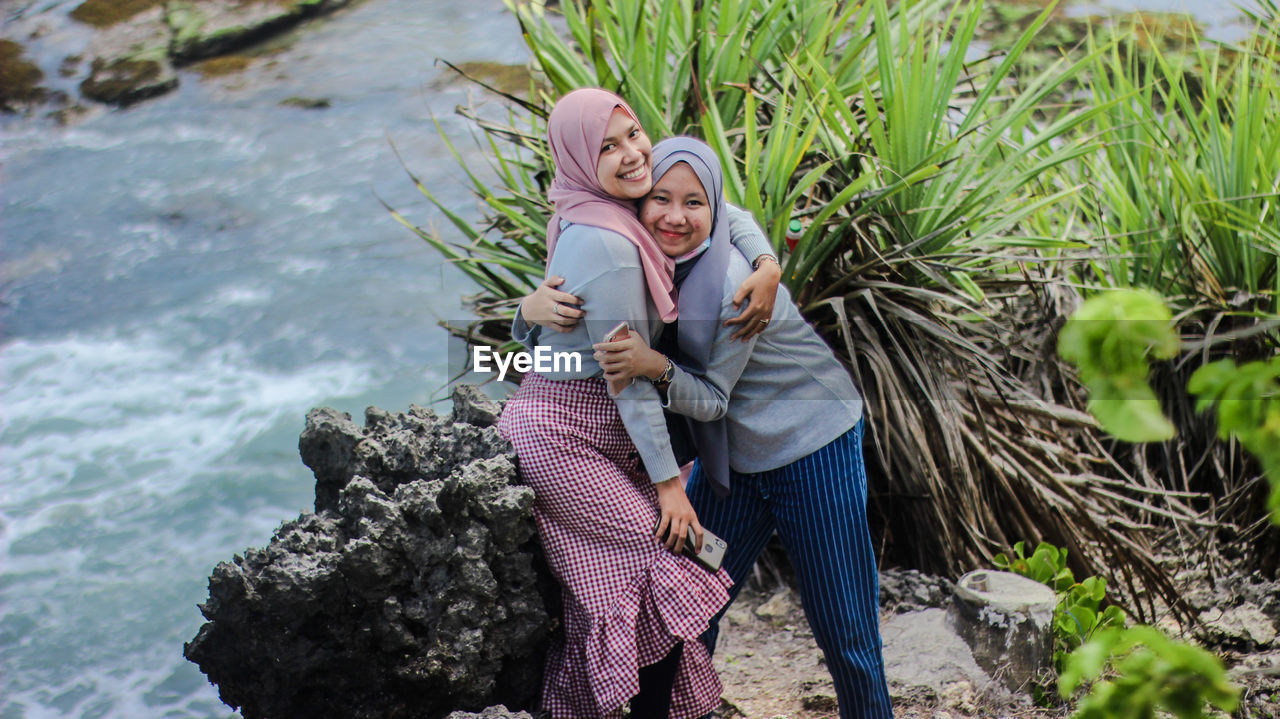 Portrait of smiling female friends wearing hijab