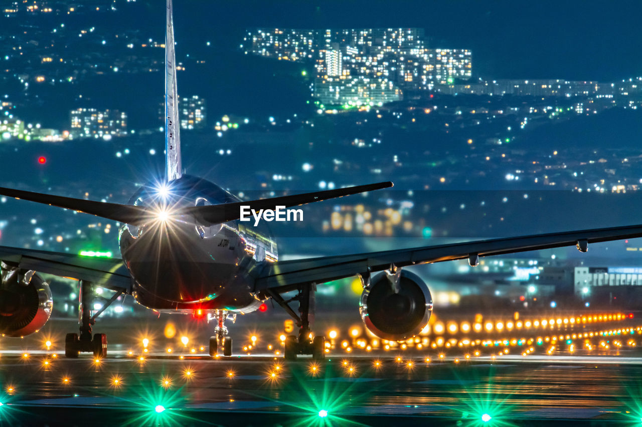 Rear view of airplane on runway at night