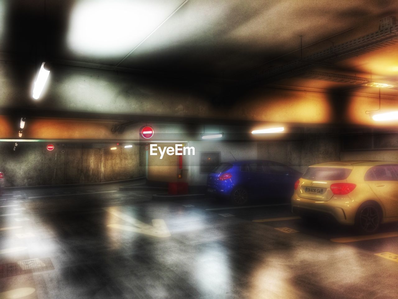 VIEW OF CAR MOVING ON ILLUMINATED UNDERGROUND WALKWAY